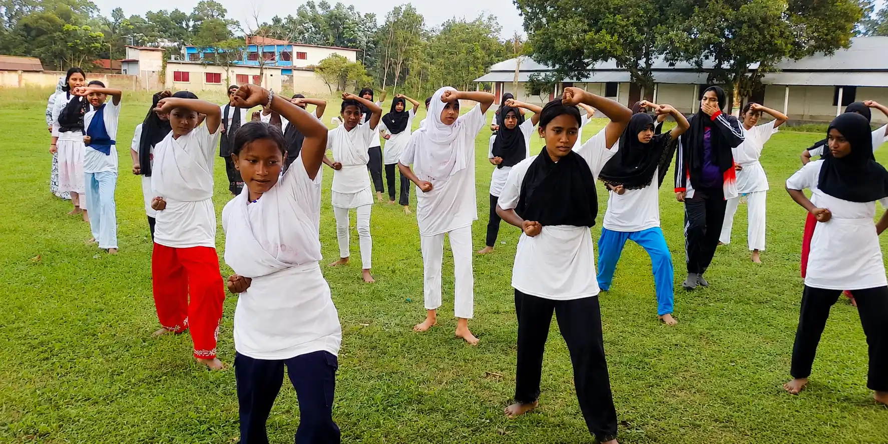 Girls practicing martial arts (Taekwondo & Karate) in field